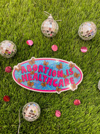A vinyl bumper sticker with glitter detail, featuring butterflies surrounding the text 'Abortion is Healthcare’. - The Peach Fuzz