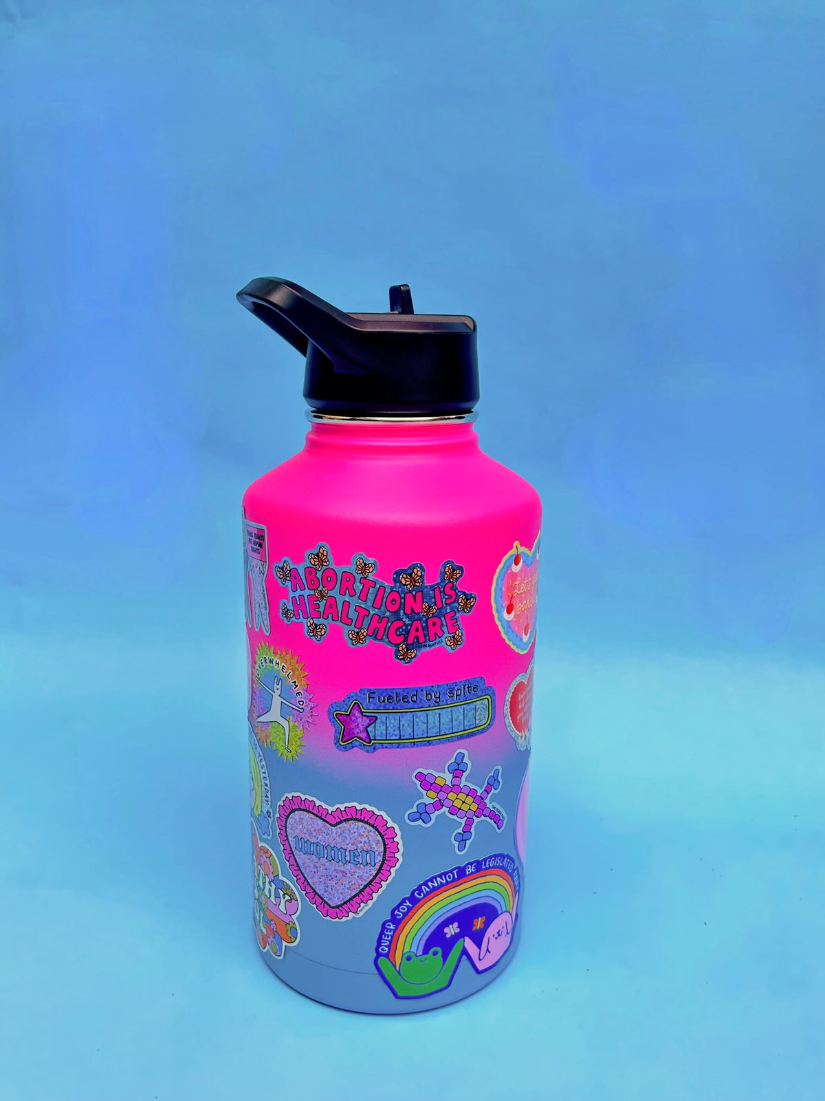 “Abortion Is Healthcare” Vinyl sticker with glossy finish and glitter detail. Measures 3.3 x 1.7 inches. - The Peach Fuzz
