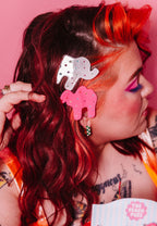 "Animal Cracker Hair Clip Set" features two clips (one pink camel, one white elephant) The "sprinkles" are made with multi color gemstones! Each clip measures 6 cm.