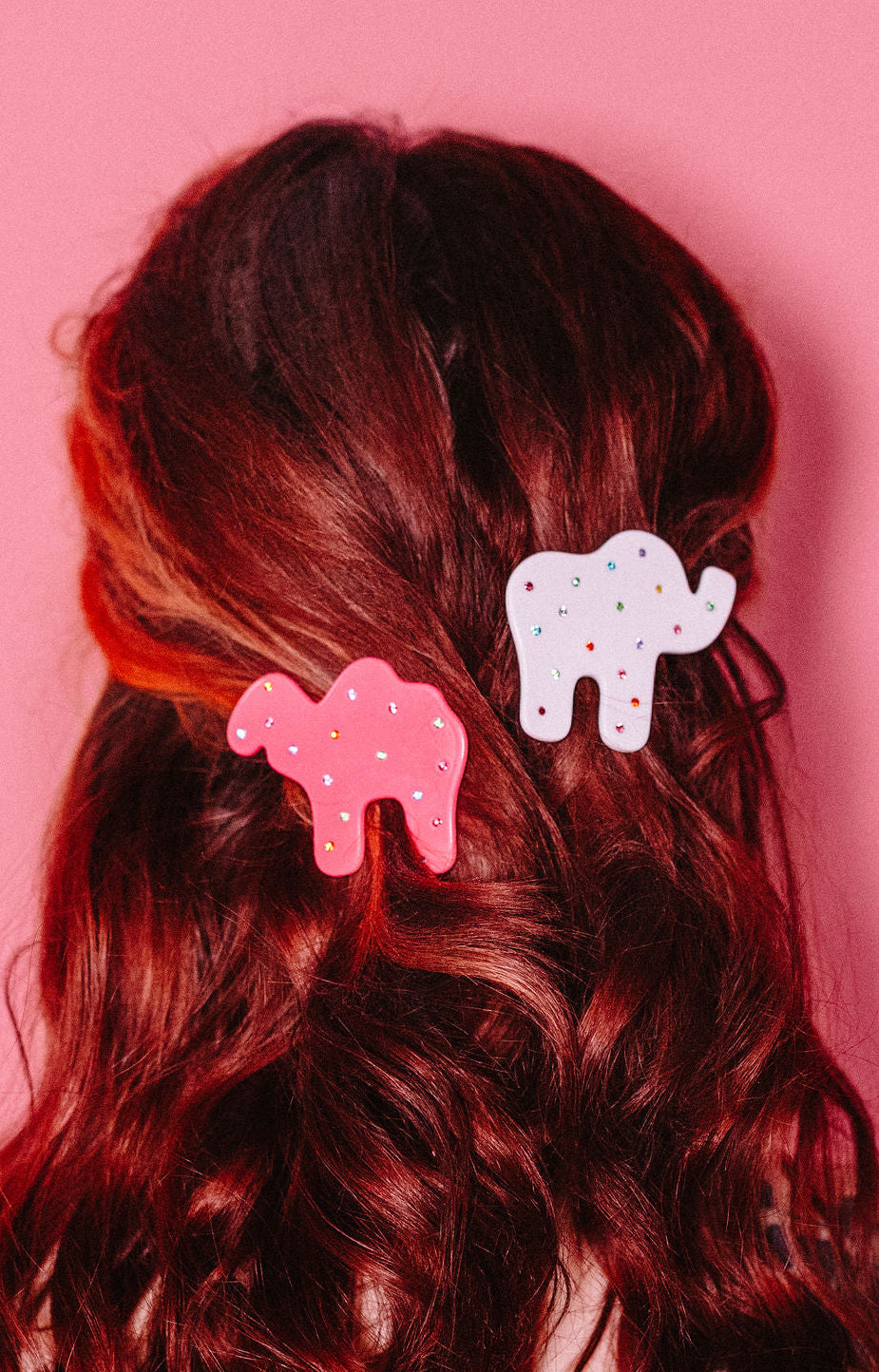"Animal Cracker Hair Clip Set" features two clips (one pink camel, one white elephant) The "sprinkles" are made with multi color gemstones! Each clip measures 6 cm.