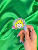 A vinyl sticker with glitter detail, featuring an illustration of a character with blonde hair, and the text 'Abortion bans are so yesterday’. - The Peach Fuzz
