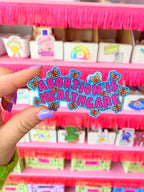 “Abortion Is Healthcare” Vinyl sticker with glossy finish and glitter detail. Measures 3.3 x 1.7 inches. - The Peach Fuzz